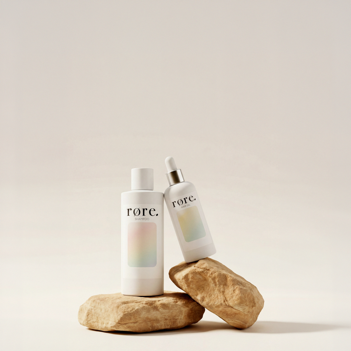 Røre shampoo and hair oil resting on stone